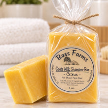 Load image into Gallery viewer, A wrapped shampoo bar with a label indicating it is made with goat's milk, in a citrus scent, from Bass Farms.
