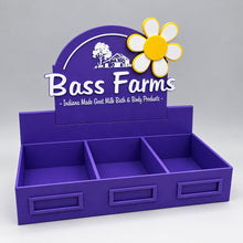 Load image into Gallery viewer, Purple display stand with 'Bass Farms' branding and a flower decoration on a white background