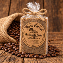 Load image into Gallery viewer, A packaged bar of Bass Farms Goat Milk Soap with Java Bean, displayed with coffee beans in the background.