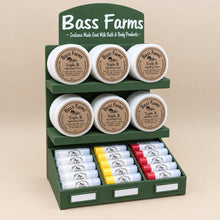 Load image into Gallery viewer, Bass Farms product display with various containers on a beige background