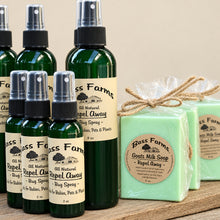 Load image into Gallery viewer, A display of Bass Farms products including bottles of Repel Away bug spray and a bar of goat milk soap.