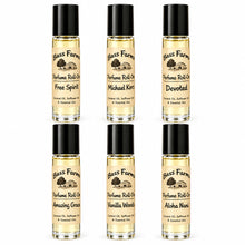 Load image into Gallery viewer, Six small glass perfume roll-on bottles with black caps arranged in two columns of three on a white background. The labels show the Bass Farm logo and names including Free Spirit, Michael Kors, Devoted, Amazing Grace, Vanilla Woods, and Aloha Nani.