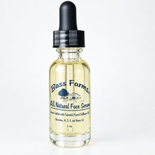 Load image into Gallery viewer, A clear glass bottle with a dropper containing face serum, labeled 'Bass Farms', placed against a wooden background.