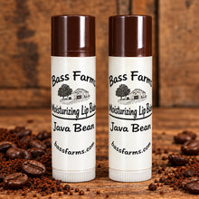 Load image into Gallery viewer, Two lip balm tubes with brown caps, labeled Java Bean Lip Balm. One tube is slightly in front of the other, set against a wooden background.