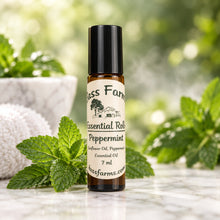 Load image into Gallery viewer, A roll-on bottle of essential oil with a label that reads 'Peppermint'. The bottle is made of amber glass with a black plastic roller ball and lid.